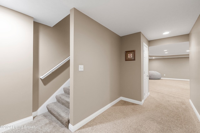 hallway with carpet, recessed lighting, baseboards, and stairs