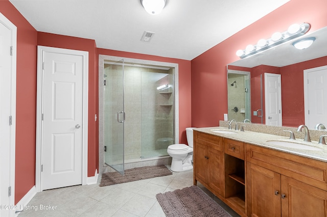 bathroom with tile patterned floors, a sink, a shower stall, and double vanity