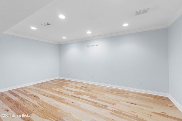 empty room with recessed lighting, light wood-style flooring, visible vents, and ornamental molding