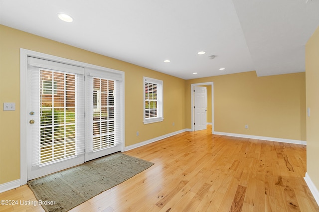 entryway featuring light wood-style floors, baseboards, and recessed lighting