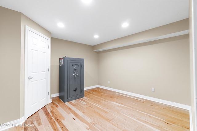 spare room featuring recessed lighting, wood finished floors, and baseboards