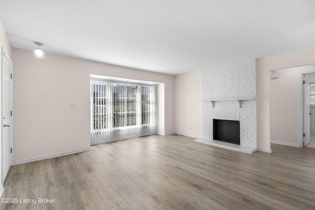 unfurnished living room featuring a fireplace and light wood-type flooring