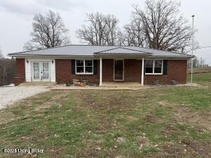 single story home with covered porch and a front lawn