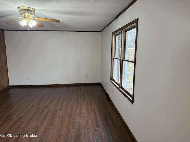 empty room featuring crown molding, dark hardwood / wood-style floors, and a textured ceiling