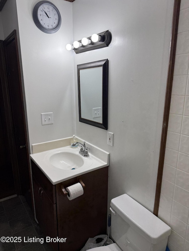 bathroom with vanity, tile patterned floors, and toilet