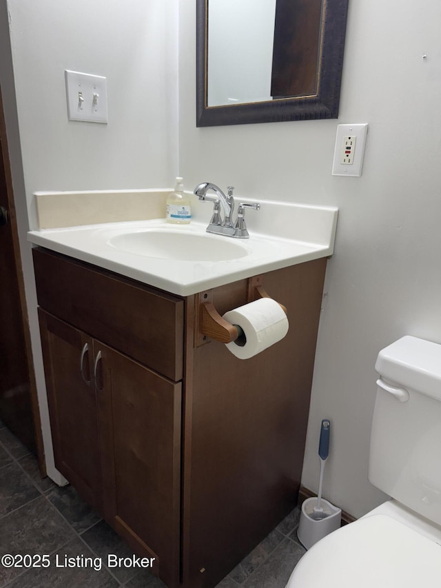 bathroom featuring tile patterned floors, vanity, and toilet