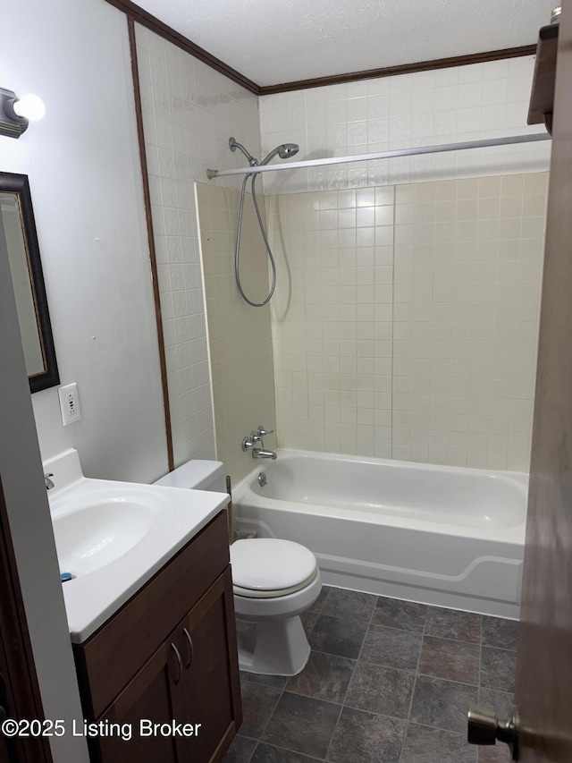 full bathroom with tiled shower / bath, ornamental molding, vanity, toilet, and a textured ceiling