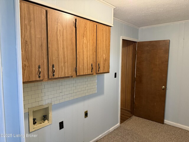 laundry room with cabinets, washer hookup, crown molding, hookup for an electric dryer, and a textured ceiling