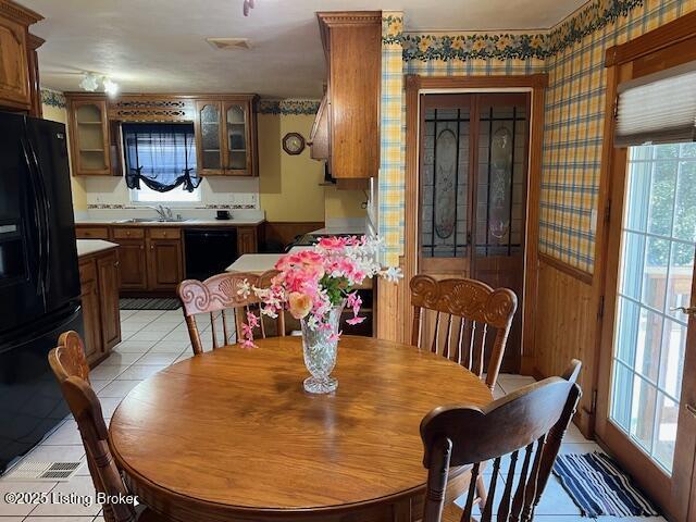 dining space featuring wallpapered walls, visible vents, and light tile patterned floors