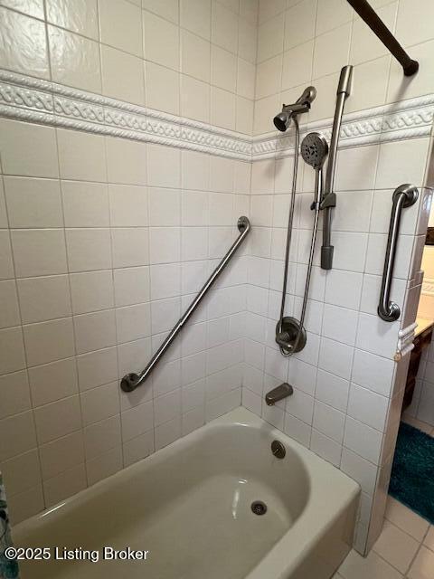 full bathroom featuring bathing tub / shower combination and tile patterned flooring