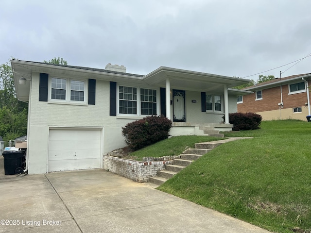 ranch-style home featuring brick siding, an attached garage, and a front lawn
