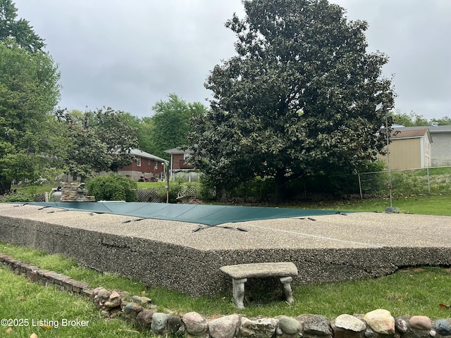 view of pool featuring fence