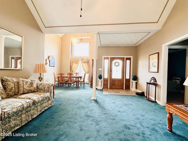 foyer entrance featuring decorative columns and carpet floors