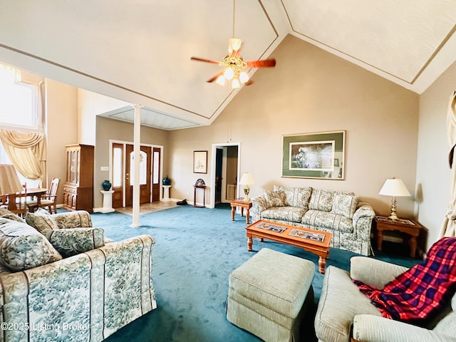 living room with ceiling fan, carpet flooring, high vaulted ceiling, and ornate columns