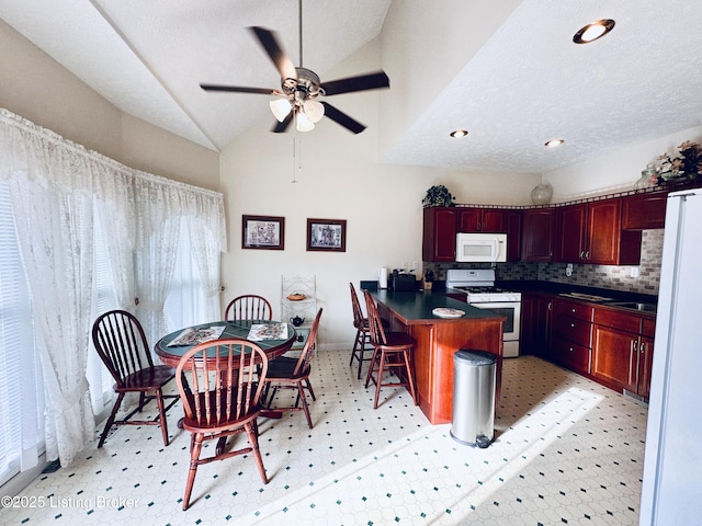 kitchen with lofted ceiling, a breakfast bar, a textured ceiling, white appliances, and decorative backsplash