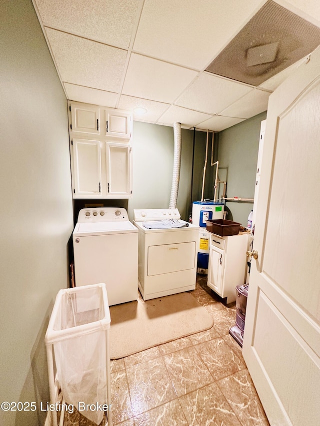 laundry room featuring cabinets, washer and clothes dryer, and electric water heater