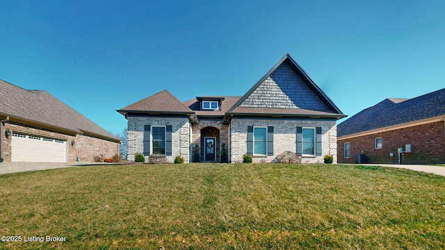 craftsman-style house with an attached garage, brick siding, a front yard, and cooling unit