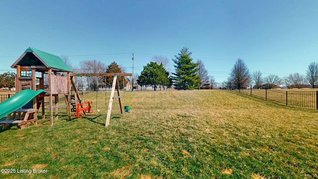 view of jungle gym with a yard and fence