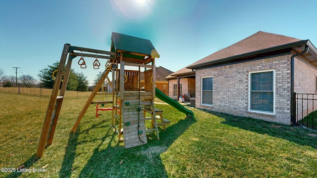 view of play area featuring a lawn and fence