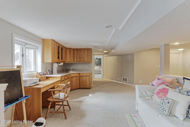 13200 Creekview Rd, Prospect, KY 40059 - kitchen featuring glass insert cabinets, visible vents, light carpet, light countertops, and a sink