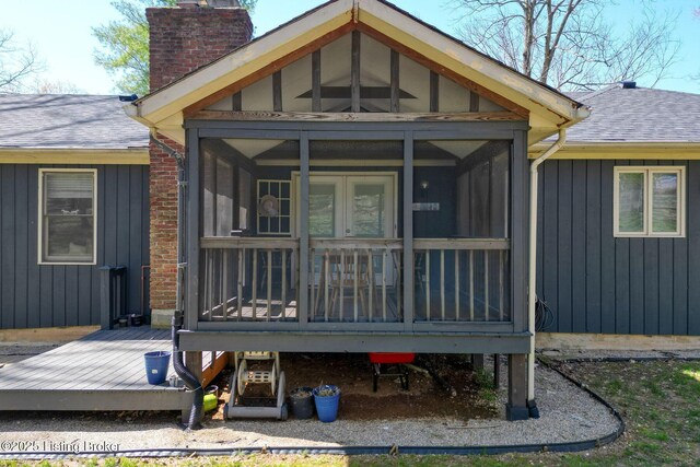 13200 Creekview Rd, Prospect, KY 40059 - rear view of property featuring a sunroom, roof with shingles, a chimney, and board and batten siding