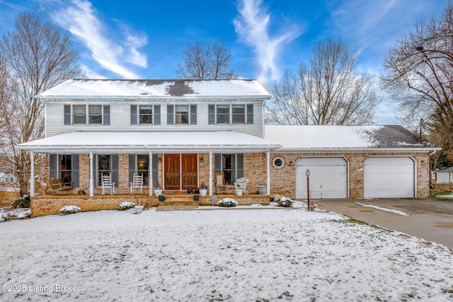 view of front of property featuring covered porch and a garage