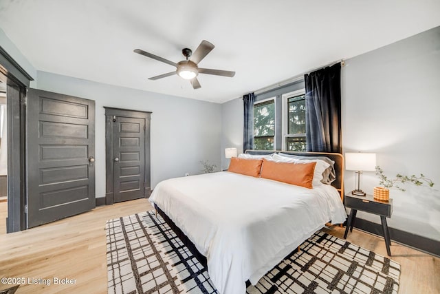 4708 S 3rd St, Louisville, KY 40214 - bedroom with light wood-style floors, a ceiling fan, and baseboards