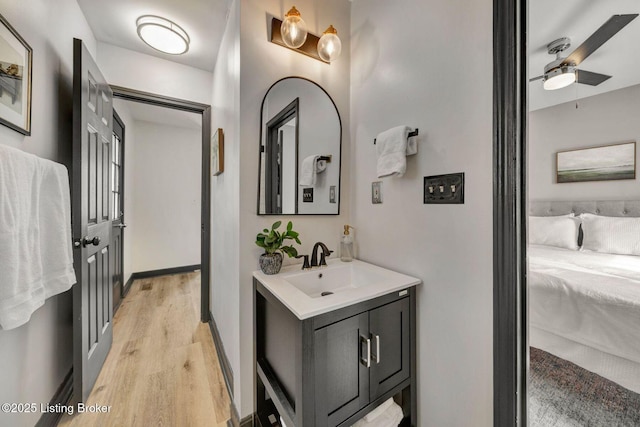 4708 S 3rd St, Louisville, KY 40214 - bathroom featuring wood finished floors, ensuite bathroom, vanity, and ceiling fan