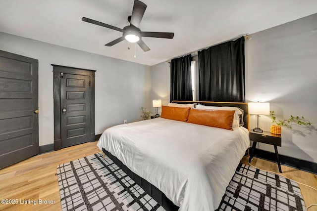 4708 S 3rd St, Louisville, KY 40214 - bedroom with light wood-style floors, baseboards, and a ceiling fan