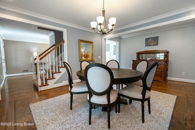 dining area featuring a chandelier, dark wood-type flooring, baseboards, ornamental molding, and stairway