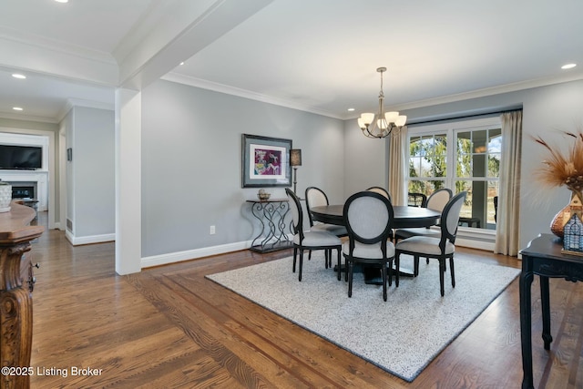 dining room featuring baseboards, ornamental molding, dark wood-type flooring, a chandelier, and recessed lighting