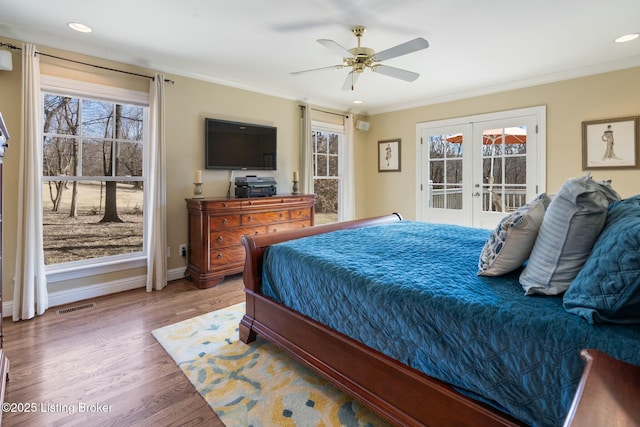 bedroom with access to exterior, multiple windows, visible vents, and french doors