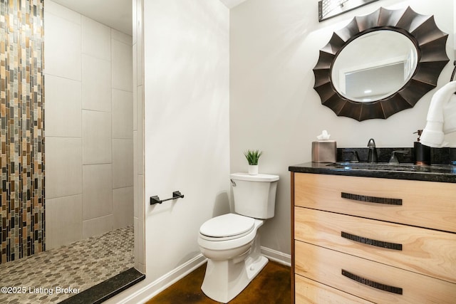 full bathroom featuring toilet, walk in shower, vanity, and baseboards