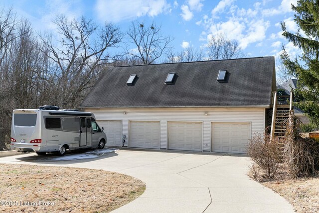 view of home's exterior featuring stairway and roof with shingles