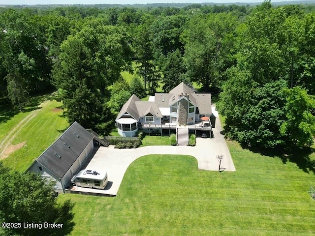 birds eye view of property with a view of trees