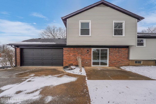 view of front of property with brick siding and an attached garage