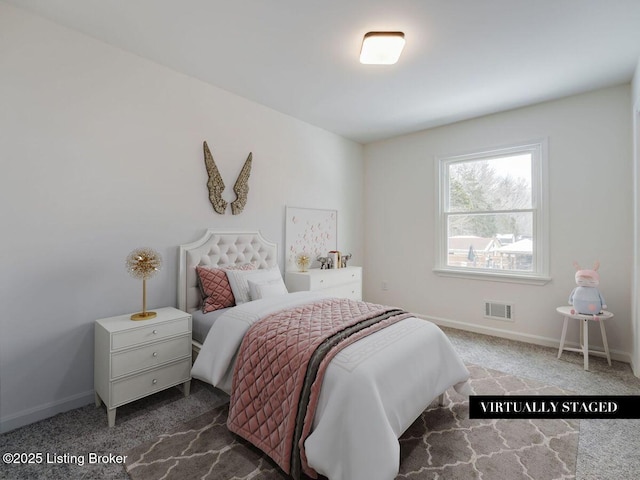 carpeted bedroom featuring baseboards and visible vents