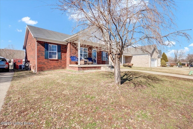 view of front of house with a porch, central AC unit, a front lawn, and brick siding