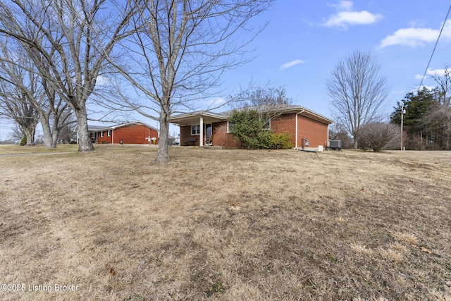 view of front facade with cooling unit, covered porch, and a front lawn