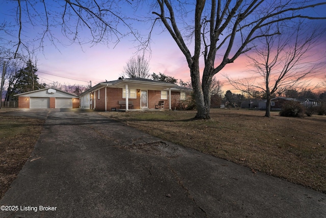 view of front of home with an outbuilding, a garage, and covered porch