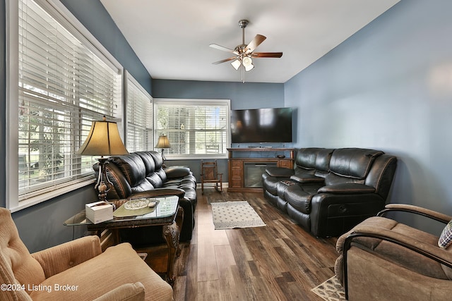 living room featuring ceiling fan, lofted ceiling, and dark hardwood / wood-style flooring