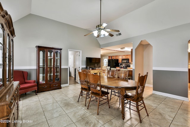 dining space featuring light tile patterned floors, high vaulted ceiling, and ceiling fan