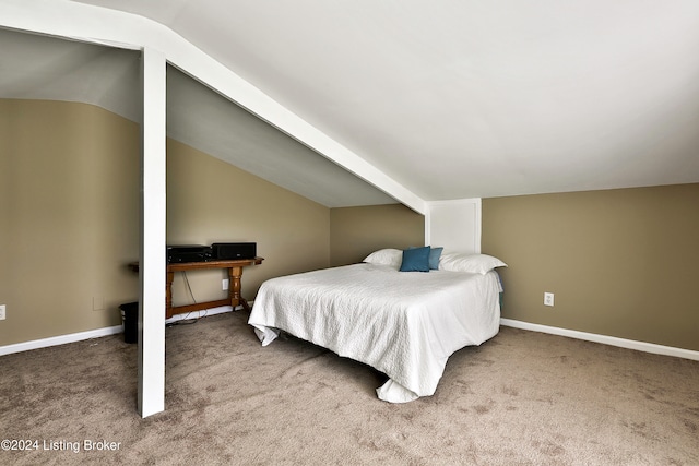 bedroom featuring lofted ceiling and carpet