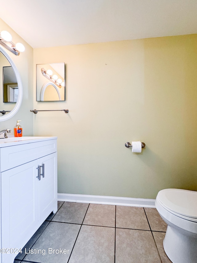 bathroom featuring vanity, tile patterned floors, and toilet