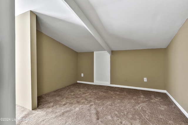 additional living space featuring lofted ceiling and light colored carpet