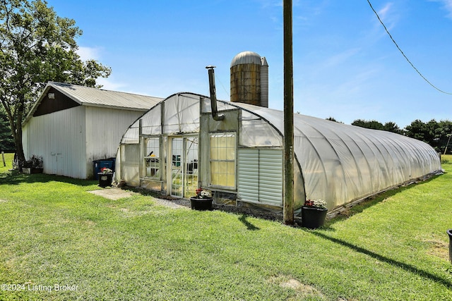 exterior space featuring an outbuilding and a lawn