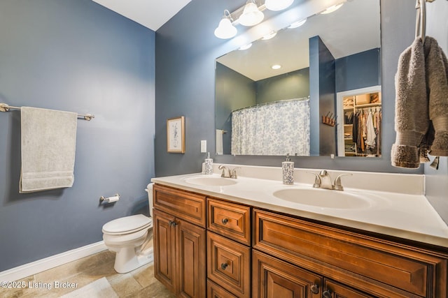 bathroom with toilet, a shower with shower curtain, and vanity