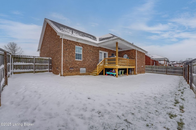 snow covered house featuring a wooden deck