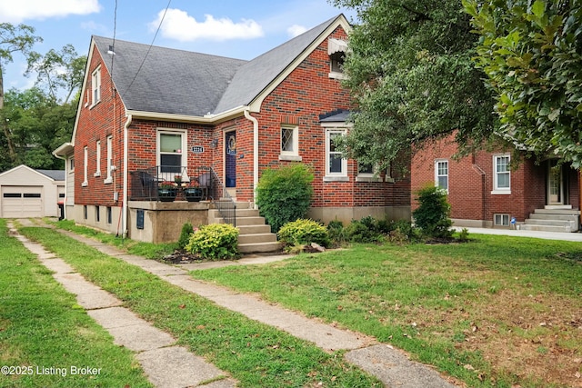 view of front of property featuring an outbuilding, a garage, and a front yard