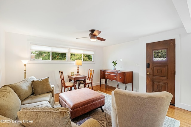 living room featuring ceiling fan and light hardwood / wood-style flooring